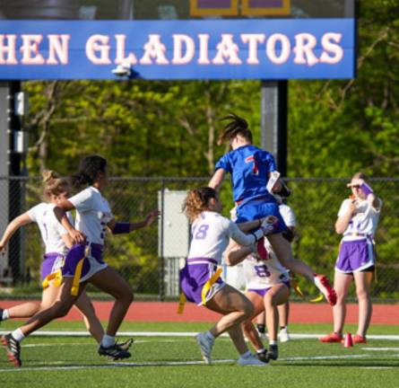 Girls on the field, ice, mat Goshen High School’s Scarlett Winkler, in blue, takes on Monroe-Woodbury last season. (Photo provided)