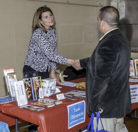 Staying healthy Photos by Mark Cranston Dr. Lora Tanis of Tanis Chiropractic shakes hands with Councilman Lou Signorino at the fair Saturday afternoon.