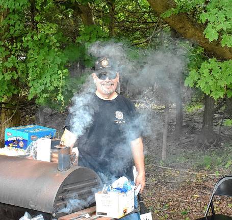 Photos: Veterans of Foreign Wars Post 7198 flag raising Post 7198 adjutant and quartermaster John Trojanowski grills burgers for the third annual Veterans and First-Responder BBQ after the flag raising.
