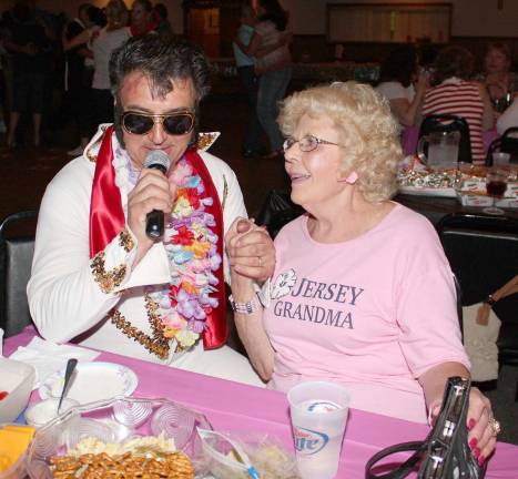 Back to the 50s at the hop Jersey Grandma, Barbara Cox, swoons a little as Elvis, also known as DJ Lou, sings "I Can't Help Falling in Love with You" at the Sock Hop.