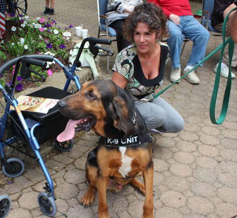 Goin' to the dogs West Millford's mayor, Bettina Bieri, gets up close and personal with one of the three bloodhounds from Southern Pride Bloodhounds in West Milford. The mayor served as judge of the contest at The Chesea at Bald Eagle.