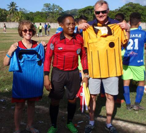 Local couple supply Honduras kids with soccer gear Photo providedCarol Louer, left, and Dr. Eric Louer, right, deliver donated soccer equipment to a leage in need in Honduras.