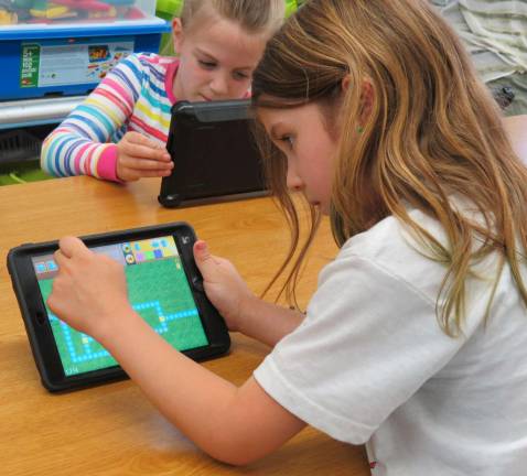 Marshall Hill kids learn to program with Kodable Kids worked to get their Smeaborg through a maze using arrows and numbers to program it.