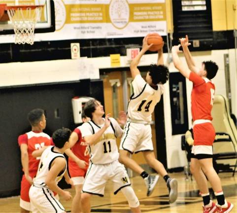 Highlanders senior Kevin DeRaffele puts up a shot over Fair Lawn defenders.