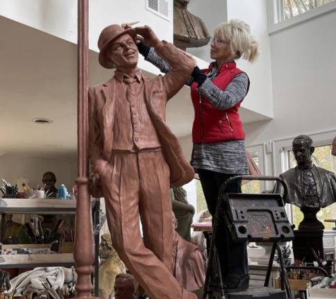 Sculptor Carolyn Palmer working on her statute of Frank Sinatra in her studio in Saddle River, New Jersey. Provided photos.