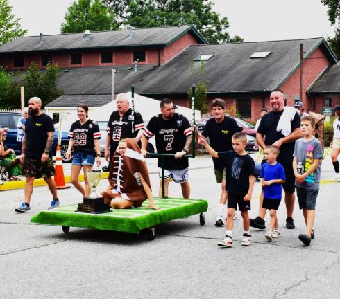 Bed race returns to village The Murphy’s team carries the trophy in the parade before the race.