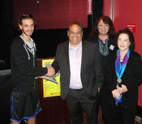West Milford kids score big at Passaic County Film Festival Matt Romano, second from left, received his second place trophy in the High School Documentary Short Film category for his film "The Forge: A Jewel in the Highlands." He is seen with Deborah Hoffman, director of the Passaic County Division of Economic Development, Alan Rowe Kelly, film commission member and master of ceremony, and Albert Kahwaty.