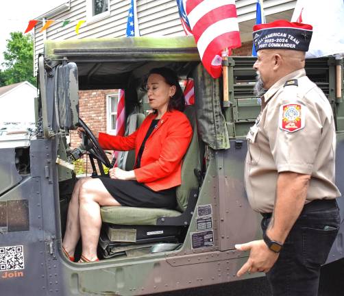 Photos: Veterans of Foreign Wars Post 7198 flag raising Post Commander Rudy Hass tells state Assemblywoman Aura Dunn, R-25, how to start the Humvee.