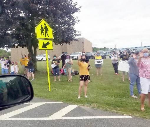 Macopin teachers, staff and school and district administrators were lined up spread out along the entire length of the grassy area in front of Macopin Middle School - from the first parking lot driveway entrance all the way to the far driveway exit near the gym.