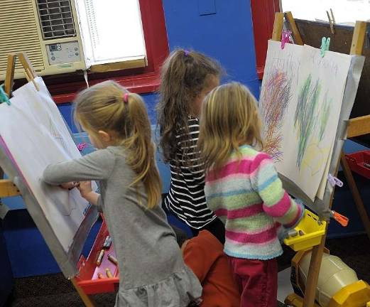 Parents rally to save township preschool Children color at the township preschool.