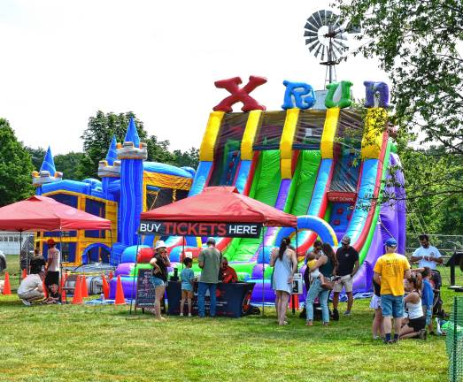 Crowd enjoys food, music, fun MF1 Children play on an obstacle course with slides and a bouncy castle. (Photos by Fred Ashplant)