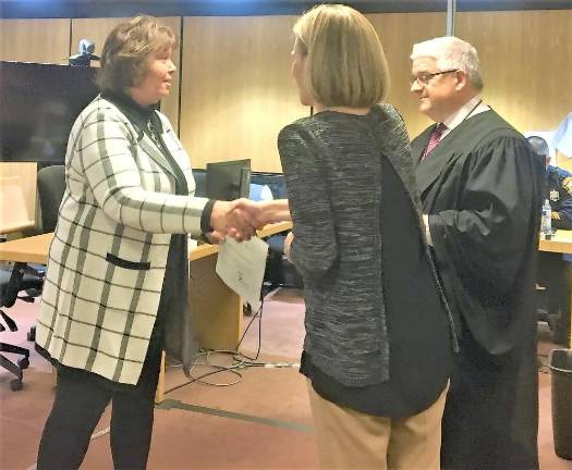 Two town residents become court advocates for foster children Meredith Nicholls (left) receives her certificate from CASA Executive Director Erica Fischer-Kaslander (middle) and Superior Court Judge Imre Karaszegi, Jr (right).