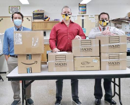 Pictured from left to right are: Macopin School Assistant Principal Oliver Pruksarnukal, Macopin Middle School Business teacher Rich Dygos and Macopin School Principal Marc Citro. The middle school’s “Operation Thank You” will deliver 100 pounds of supplies to soldiers serving overseas. Provided photo.