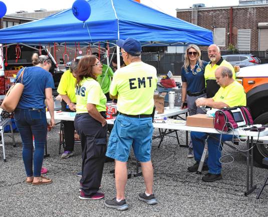Community gathers for National Night Out Emergency medical technicians demonstrate their equipment.