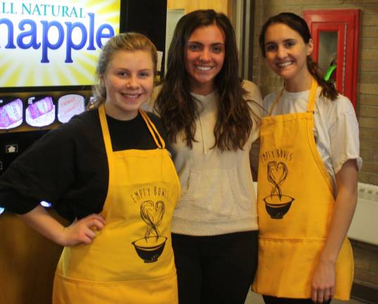 The giving was plentiful Emily Miller, 16, Christina Pellegrino, 17, and Kelsey Harrison, 16, served drinks at the Empty Bowls event.