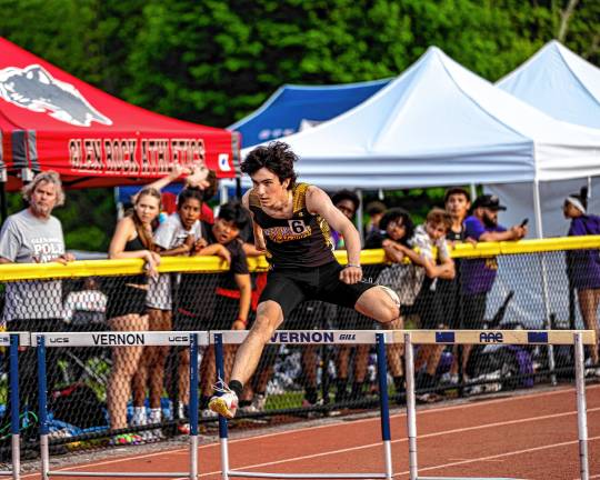 Diodonet wins gold medal WM2 Zack McDowell jumps over a hurdle. He finished 10th in the 400-meter hurdles.