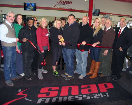 Snap Fitness 24/7 Warwick celebrates grand opening Photo by Roger Gvan On Jan. 8, Town of Warwick Deputy Supervisor James Gerstner (far right), Mayor Michael Newhard (far left) and members of the Warwick Valley Chamber of Commerce Board of Directors joined co-owners Shari McAtee-Caruso and her husband, Jim Caruso (center)and their staff for the official grand opening of the Snap Fitness new location in Warwick.