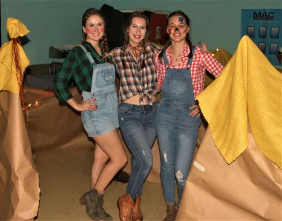 West Milford High School students Spohia Meany, 17, Kalleen Rose Ozanic, 17, and Diana Novachevska, 17, guide attendees through a &#x201c;corn maze&#x201d; during Spooktacular on Saturday.