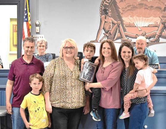 Blom honored for volunteer work Dorrie Torp poses with her family and Mayor Michele Dale.