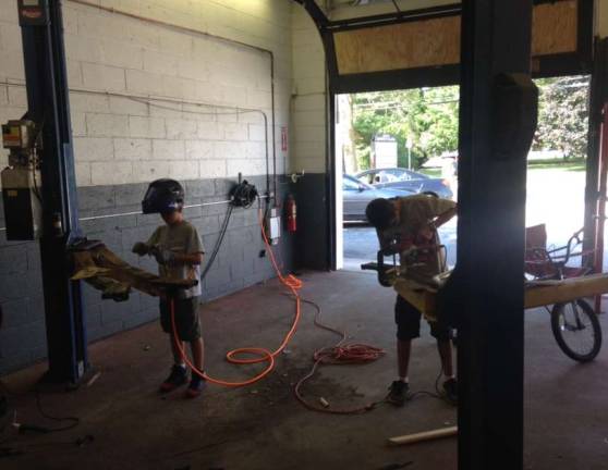 Hometown mechanic Photo provided Eric Schoemer's kids share an interest in mechanics too.