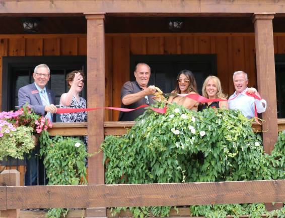 Warwick Wine Garden and Piano Bar to offer private venue for special events Photo by Roger Gavan On Aug. 2, members of the Warwick Valley Chamber of Commerce joined owner Chris Litell and Manager Lourice Angie (center) to celebrate the firm’s new direction with a ribbon cutting on the Wine Garden’s impressive New Orleans-style two-tier porch.