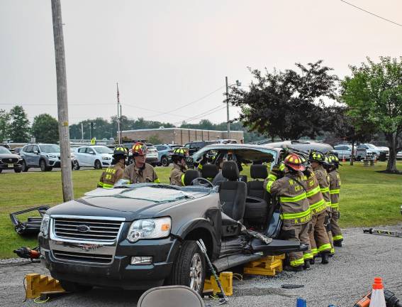 Community gathers for National Night Out Firefighters demonstrate a rescue using the Jaws of Life tool.