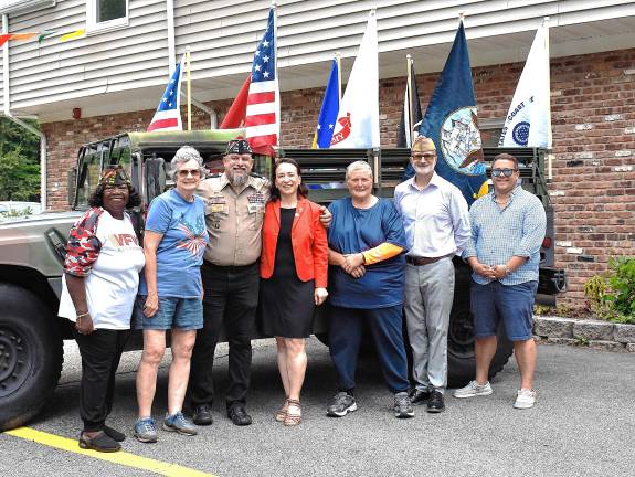 Photos: Veterans of Foreign Wars Post 7198 flag raising VFW leaders pose with state and local officials. From left are Minnie Austin, VFW Department of New Jersey Surgeon-Army; West Milford Councilwoman Marilyn Lichtenberg; Post 7198 Commander Rudy Hass; state Assemblywoman Aura Dunn; Councilwoman Ada Erik; Jon Hinker, VFW Department of New Jersey Commander-Army; and Councilman Matthew Conlon.