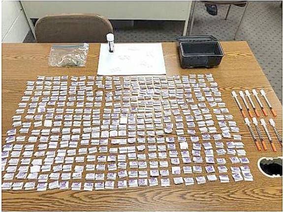 After obtaining a warrant authorizing the search of a vehicle, West Milford police recovered 390 glassines of Heroin, 50 30 mg. tablets of Oxycodone, a small baggie of marijuana and additional 9 hypodermic syringes.