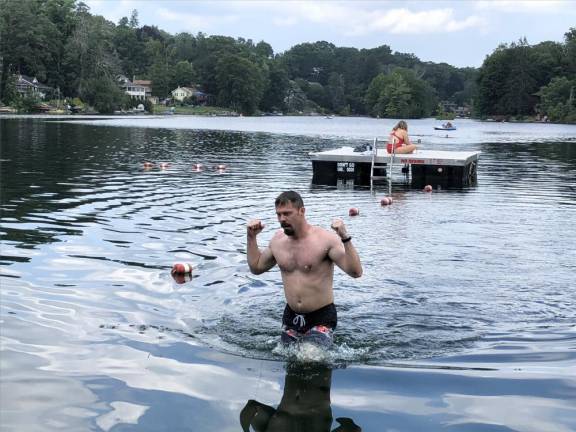 Going the distance Brian Ogilvie celebrates his first-place finish in the Lindy’s Lake Distance Swim. (Photo by Kathy Shwiff)