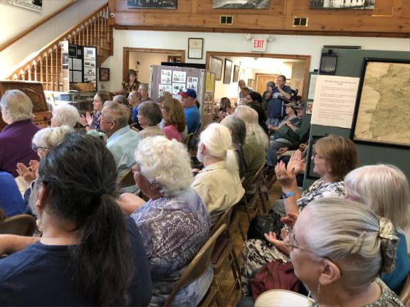 Members of the audience clap to a song.