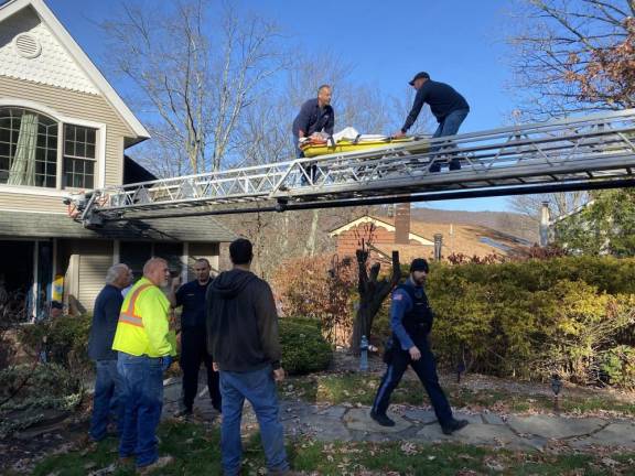 RG3 Firefighters help move Rich Grehl out of his Hewitt house after he had a heart attack on the third floor Nov. 4. Protocol calls for the patient to lie flat so he could not go down the spiral staircase. (Photo provided)