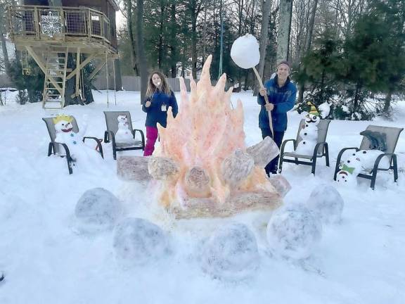 The Iwaszczuk family had fun in the snow creating these whimsical snow family sculptures around an amazing snow-campfire scene. Photo provided by Jennifer Iwaszczuk.