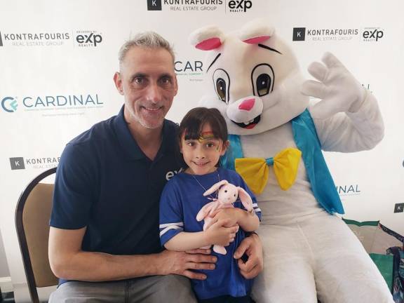 Jeffrey Struck and his daughter Samantha, 5, pose with the Easter Bunny.