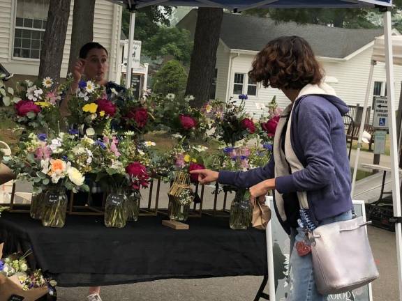 A shopper stops at the Floral Ideology stand.