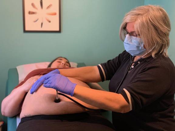 Midwife Susanrachel Birdie Condon with her client, Anique Nicholson. Midwives wear N95 masks and gloves, but the reality is that some of us will become ill during this time, the midwives said in an open letter.