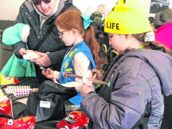 Children look at model airplanes inside the Elks Lodge.