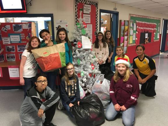 Westbrook students collect hats, mittens for children in need Photo provided Students at Westbrook Elementary School gather around the Christmas tree with bags of hats, gloves/mittens and pajamas. The donated clothing helped more than 100 local children in need.