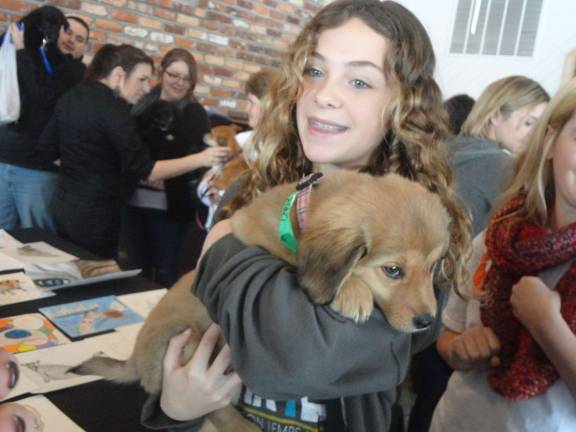 Mohawk House goes to the dogs for O.S.C.A.R. fundraiser Photos by Scott Baker Regan Thiel, 13, of Andover, gets to know O.S.C.A.R. rescue Charlie.