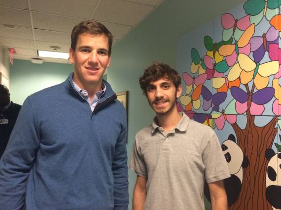 Local teen filmmaker a finalist in film festival Matt Romano, right, is seen here with Giants quarterback Eli Manning. Matt was part of a project through the Passaic County Technical Institute that filmed a piece on Manning at Hackensack University Medical Center and MetLife Stadium.