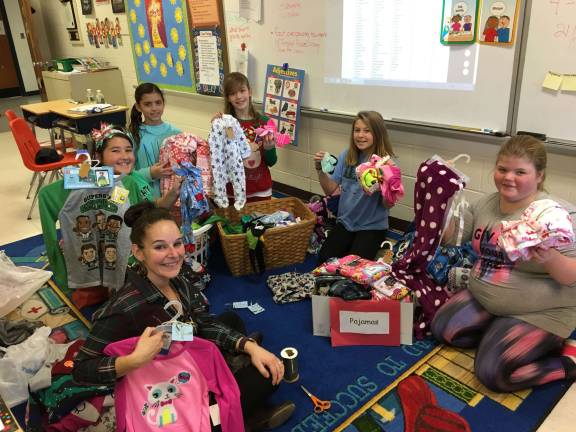 Westbrook students collect hats, mittens for children in need photo provided Members of Westbrook Cares, a social action group at Westbrook Elementary School, tag and sort hats, gloves/mittens and pajamas for St. Joseph R.C. Church's "Spirit of Christmas" drive.
