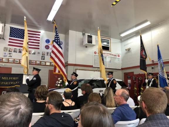 The color guard marches in with flags.