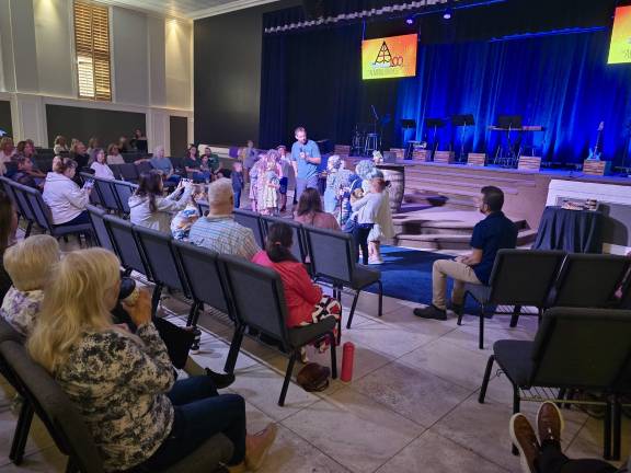 Church celebrates centennial Children in a centennial skit with Family Pastor Jeff Gunther. (Photo provided)