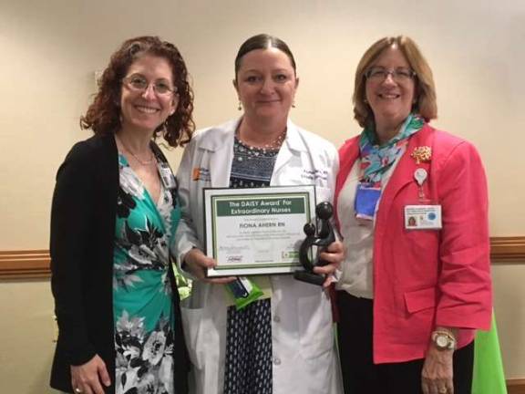 Chilton Medical Center nurse receives DAISY Award Stephanie Schwartz, Chilton Medical Center president, and Dr. Maureen Schneider, the center's chief nurse and operations officer, flank Fiona Ahern, recipient of the DAISY Foundation Award.
