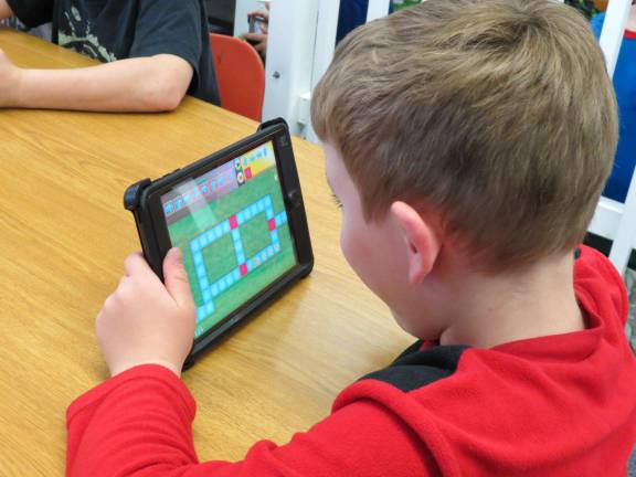 Marshall Hill kids learn to program with Kodable Kids worked to get their Smeaborg through a maze using arrows and numbers to program it.