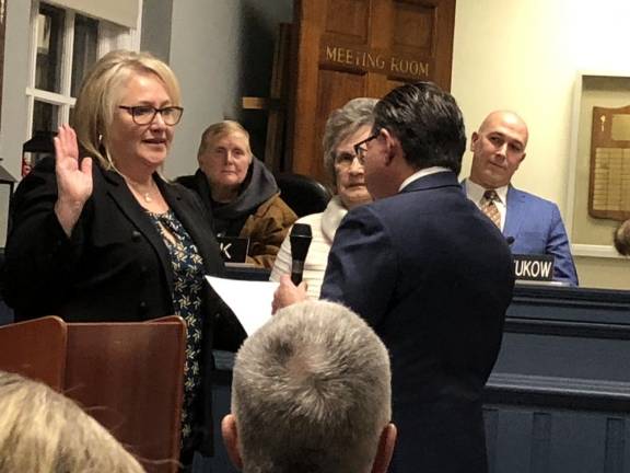 Mayor Michele Dale is sworn in for her second term at the Township Council’s annual reorganization meeting Wednesday, Jan. 3. Councilwoman Marilyn Lichtenberg holds the Bible and state Sen. Anthony Bucco, R-25, administers the oath of office. (Photos by Kathy Shwiff)