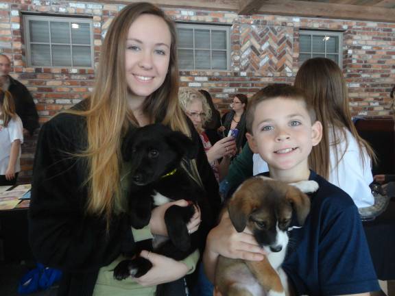 Mohawk House goes to the dogs for O.S.C.A.R. fundraiser Alex Flockhart, 9, and Shaye Daly, 15, both of Sparta, spend some time with O.S.C.A.R. rescues Christian and Tippy.