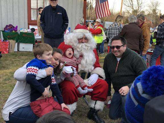 A family poses with Santa.