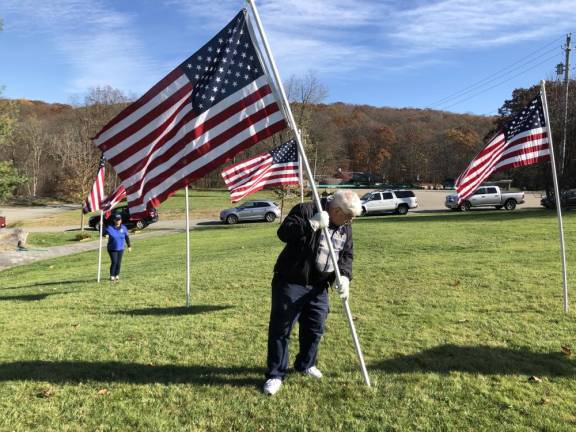 RF4 Gery Threlfall plants a flag. At left is Cindy LeMay. (Photo by Kathy Shwiff)