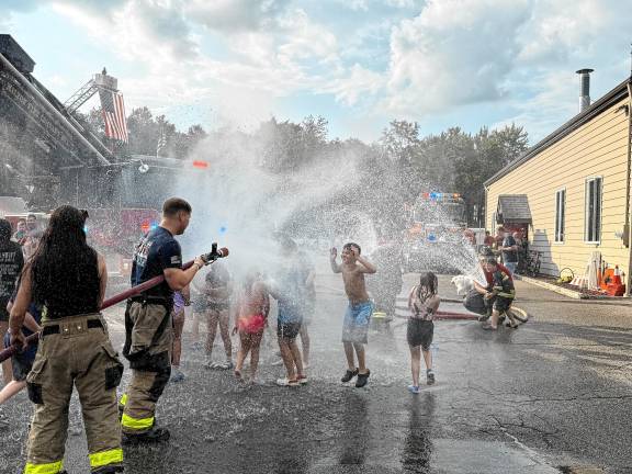 Photos: Wetdown of ladder truck in Jefferson Children play in the water during a wetdown of the new ladder truck Saturday, Aug. 16 at Jefferson Township Fire Department Company 1. (Photos by Denise von Wilke)