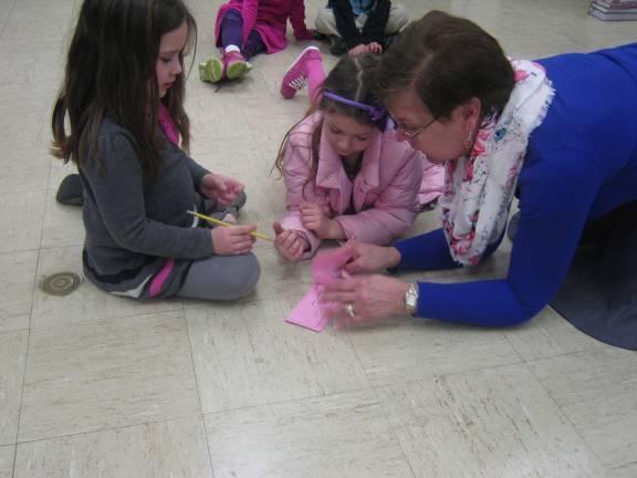 Students, teachers show the 'heart' of Ringwood Christian School Teacher Cheryl Bradon works with students to complete a math relay.